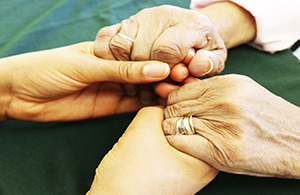 Two people's clasped hands